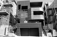 A black and white photo of a series of condos with sharp angles. 