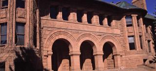 Palmer Hall, a red sandstone Romanesque Revival style building at Colorado College.