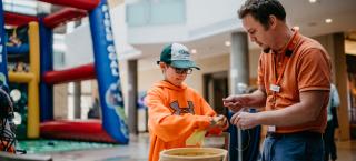 Boy making craft with fort in background