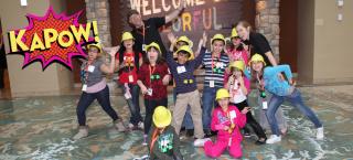 Kids in front of Colorado sign with kapow logo