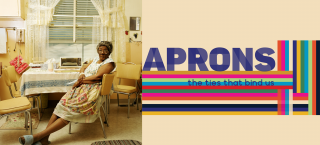 Photo of a woman with an apron sitting at her home