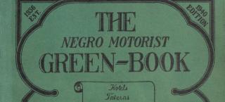 Image (cropped to the top half) of the cover of the 1940 Negro Motorist Green Book. The cover is medium green paper, printed in black ink. The book title and other text descriptions are edged by a rounded border.
