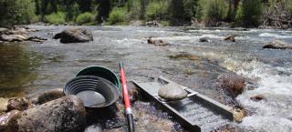 Gold panning supplies: gold pan, classifier, shovel, and sluice.