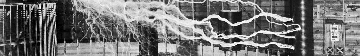 A multiple exposure picture of Tesla sitting next to his "magnifying transmitter" generating millions of volts. The 7-metre (23 ft) long arcs were not part of the normal operation, but only produced for effect by rapidly cycling the power switch.