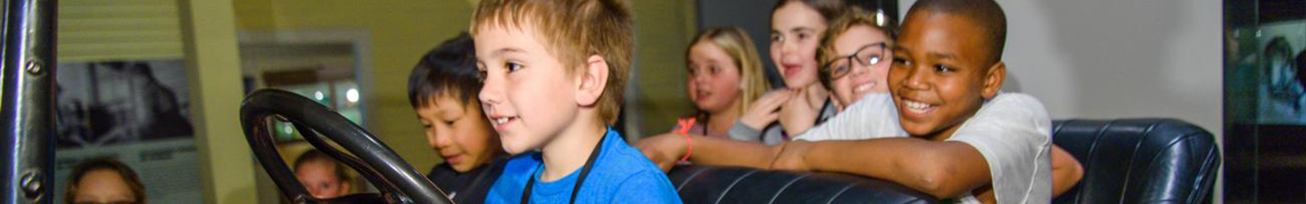Kids in car in exhibit