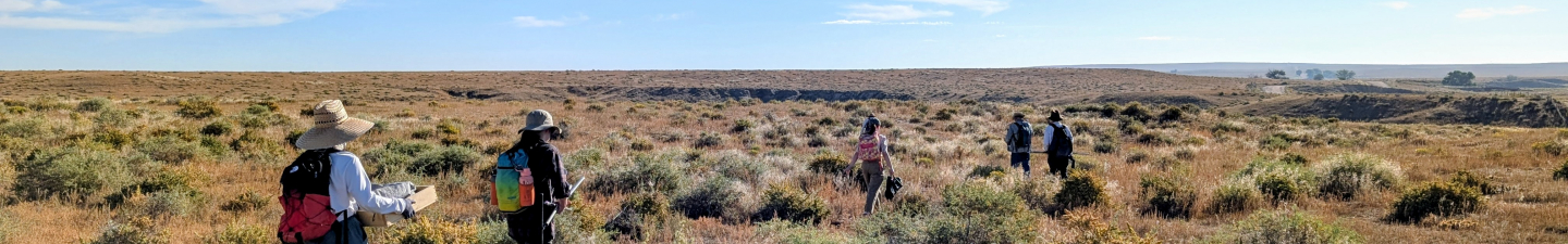 PAAC volunteers carrying field gear to site