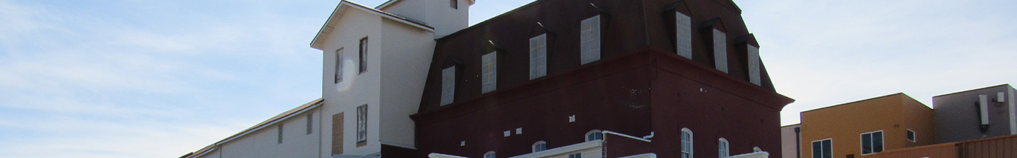 Exterior of Loveland Feed and Grain with restored windows and new paint.