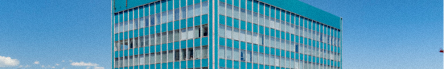 Exterior of 655 Broadway, the turquoise multistoried offices in Denver.