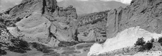 Black and white photo of the Garden of the Gods, with Pikes Peak visible between the outcrops.