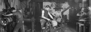 Men working with type on rollers in the printing room of the Rocky Mountain News, 1900s-1910s.