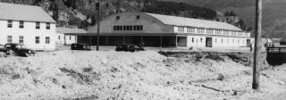 A larger building with an arced roof in the center of Camp Hale.