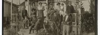 Japanese Americans on the porch of a house in Bessemer