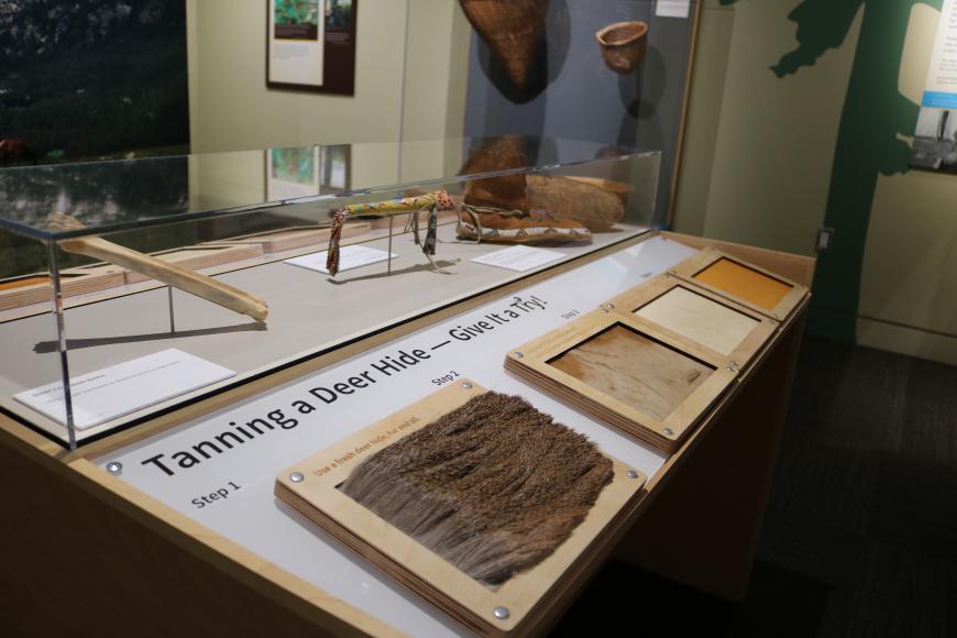 Items on display in the Ute Indian Museum Exhibit. The items include furs and pelts open to the air, available to be touched. A sign invites visitors to touch them.