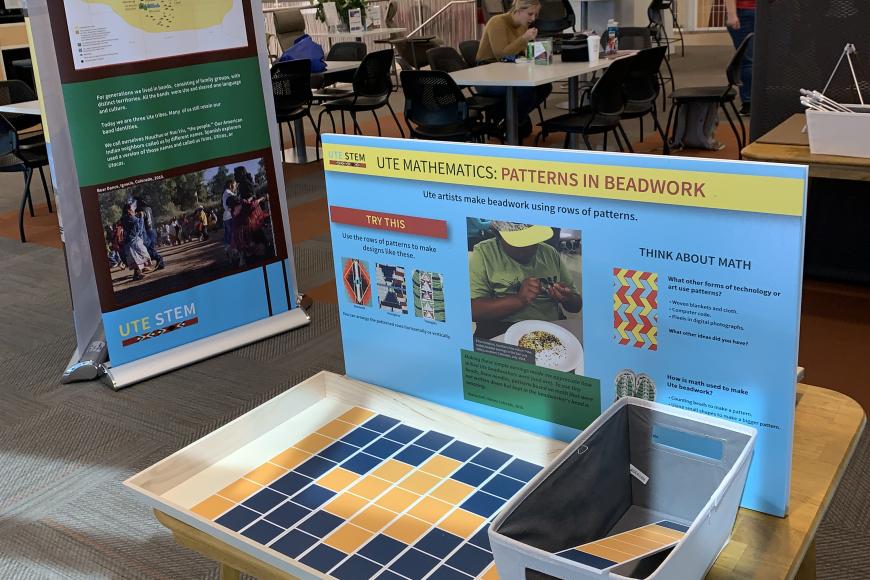 A pop up panel and interactive exhibit on display in a public space at a community college building.