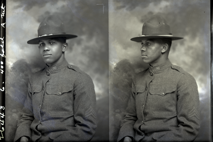 The negative shows two separate exposures of Cruter. Both exposures show only his head and bust. In the image on the left Cruter is looking into the camera, while the image on the right is of his profile. Cruter poses in his infantry uniform. He wears his wool service coat buttoned to the top and service hat. His collar disc is composed of two crossed rifles. On the sleeve of his right arm a Sergeant insignia is visible. A studio backdrop is visible behind him.