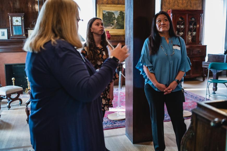 Tour given to two visitors in the library at the center for Colorado women's history.
