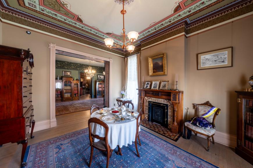 Interior of historic parlor filled with antique furnishings at Center for Colorado Women's History.