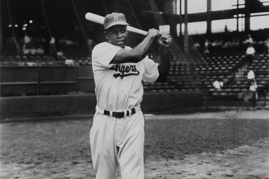Jackie Robinson swinging with a bat
