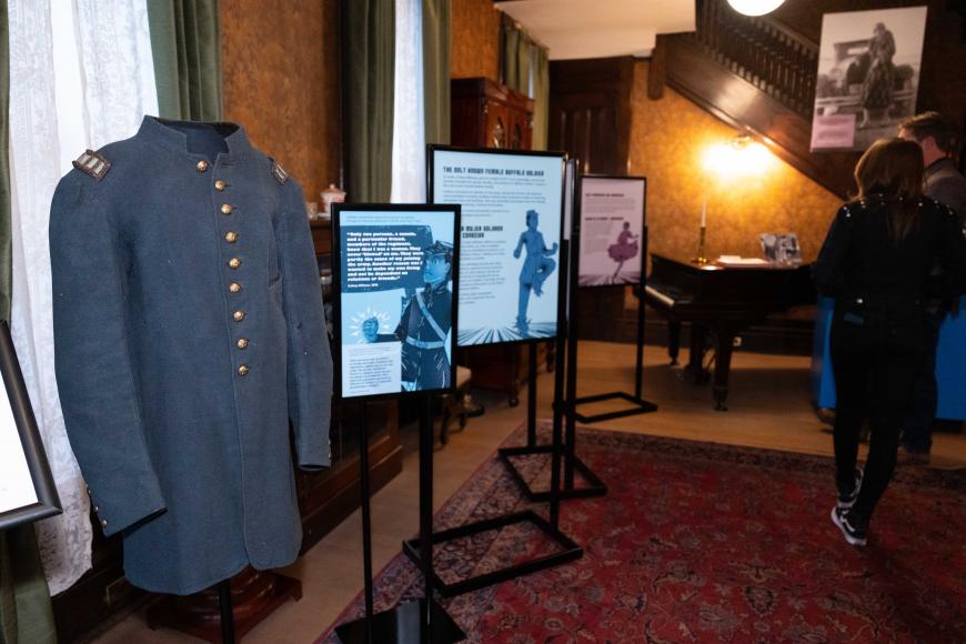 Mannequin in a Civil War Buffalo Soldier jacket next to information panels as part of the Ms Destiny exhibition.
