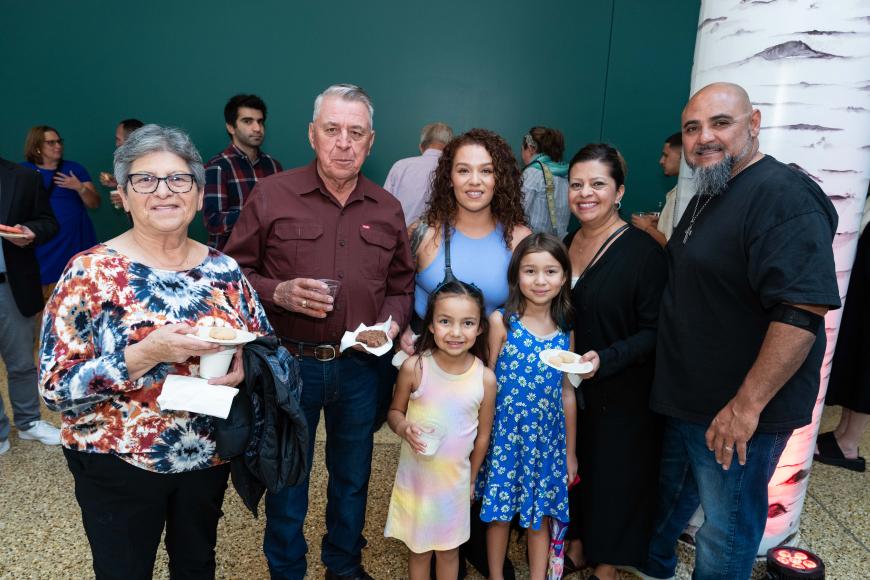 A group of adults and children gathered at an event.