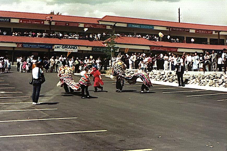 A large crowd in the Far East Center watches a lion dance performance.