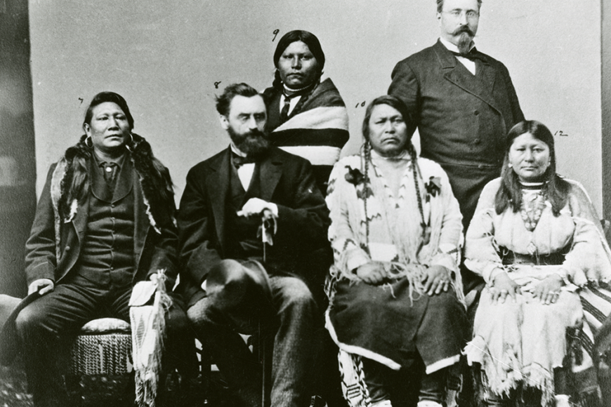 Chipeta stands, posing to the camera with other Ute tribal members and a few white settlers.