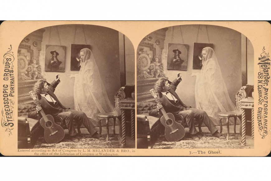 A musician is startled by the appearance of a ghost of a woman in a flowing gown. She is partially transparent.