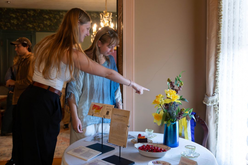 Woman pointing at flowers in exhibit