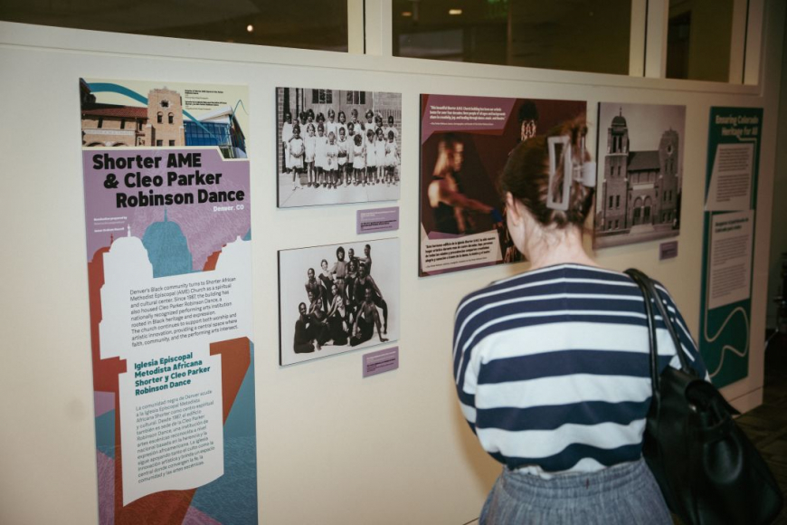 Woman observing Shorter AME & Cleo Parker Robinson Dance portion of Keeping Place exhibit
