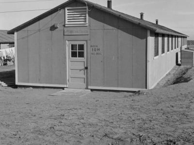 Photo from Amache internment camp in 1943 - a wooden framed, one-story building named Block 10-H