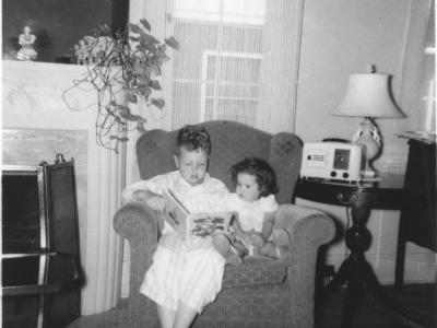Ten-year-old Dick Rogers reading to his two-year-old sister, Donna, in their Denver home, June 1950. History Colorado. 2020.36.71