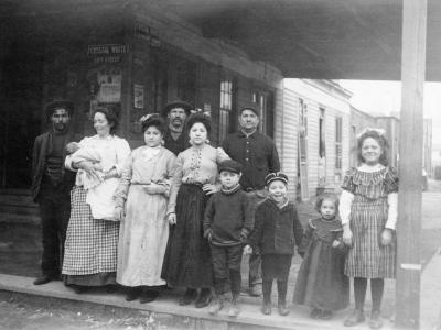 Italian families pose near shop