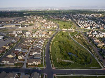 Photo of the Central Park (formerly Stapleton) area of Denver, aerial view. In the distance the skyscrapers of downtown Denver can be seen, as well as the mountains of the Front Range.
