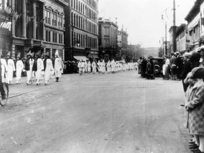 Ku Klux Klan members march down Larimer Street in Denver, 1926.