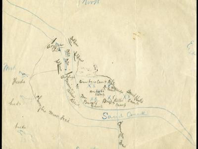 Image of a hand-drawn map on white paper. The map indicates North at the top of the page and South at the bottom; in thin cursive handwriting, the Sand Creek snakes its way from the left of the map, down to the south. There are "X" marks alongside the creek, with names that suggest who was positioned in the area. "Chivington Trail" is legible along a path leading from the south up north to the area where others were situated along the creek.