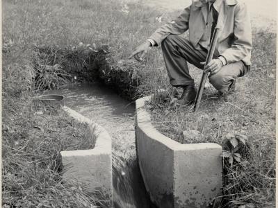 Ralph Parshall checks on one of his flumes.