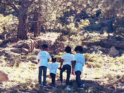 A group of children, relatives of Judge Gary Jackson, hiking to the top of Winks Trail
