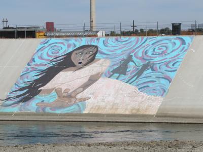 A mural depicting La Llorona on the Arkansas River Levee in Pueblo