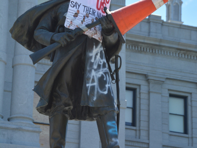 The Colorado State Capitol Civil War monument, vandalized with a sign that reads "Stop Killing Us."