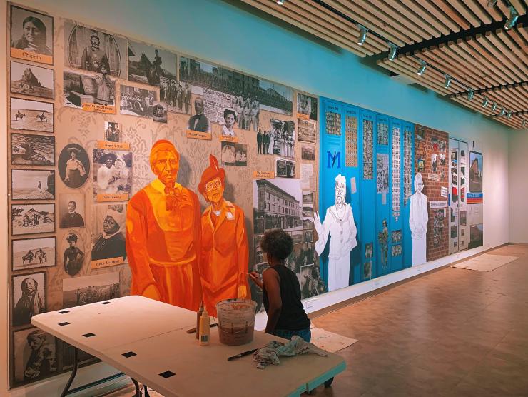 Artist Adri Norris making progress on the Five Points Plus exhibit mural.