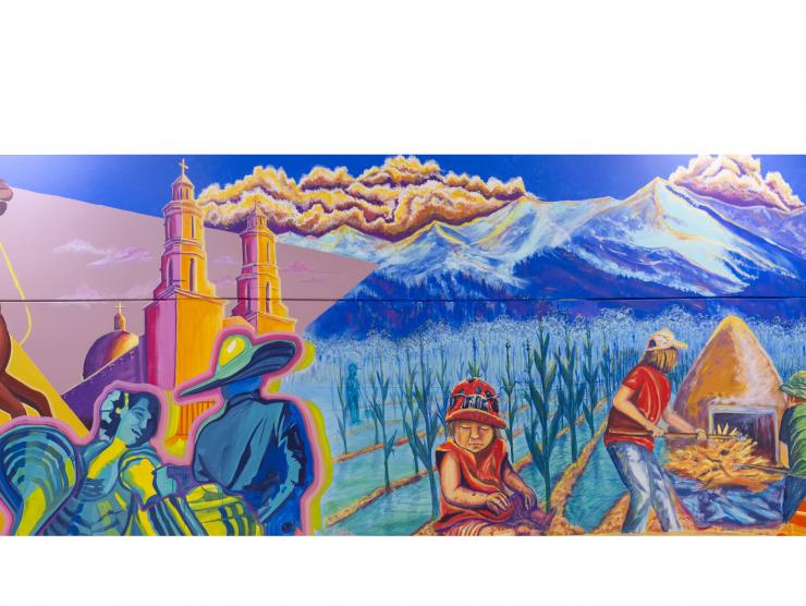 Mural of a collage of images: An eagle fighting a snake, a man riding a horse, a mountain-scape, a hummingbird, a car and people in a field.