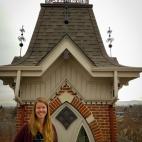 Photo of author Katie Arntzen, standing in front of an ornate building