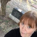 Shaun Boyd photograph. She has bangs and short hair that is red and wears a black top.