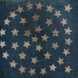 blue section of US flag with 38 stars arranged in a circle.
