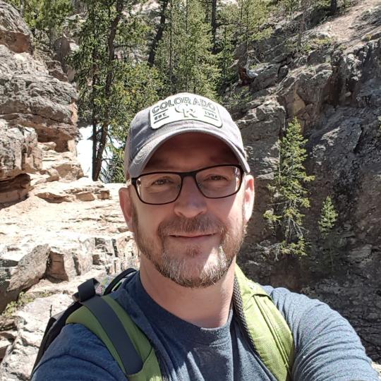 Chris Bowles with an outdoor backdrop